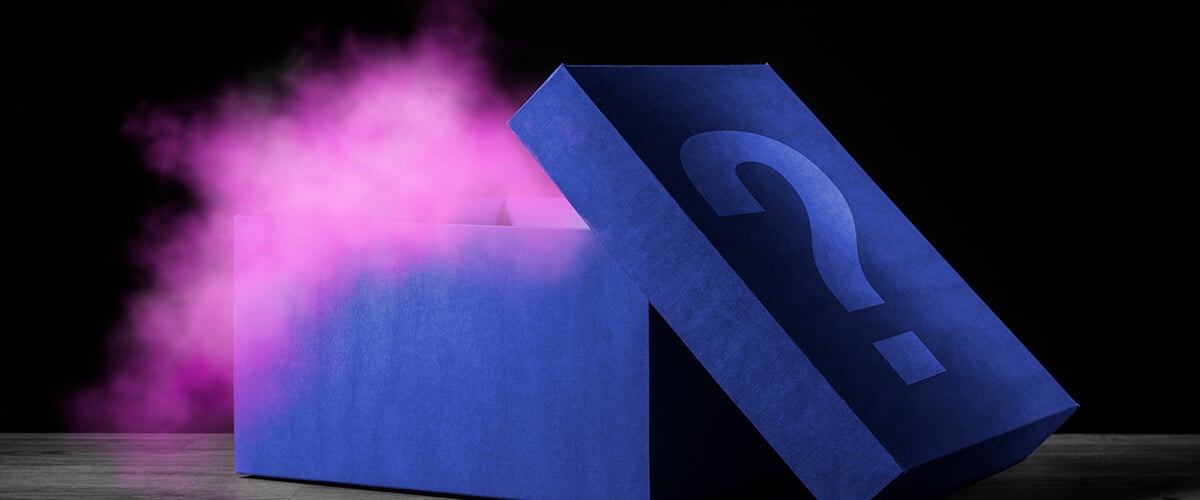 Open blue mystery box emitting pink smoke, with a question mark symbol on the lid against a dark background.