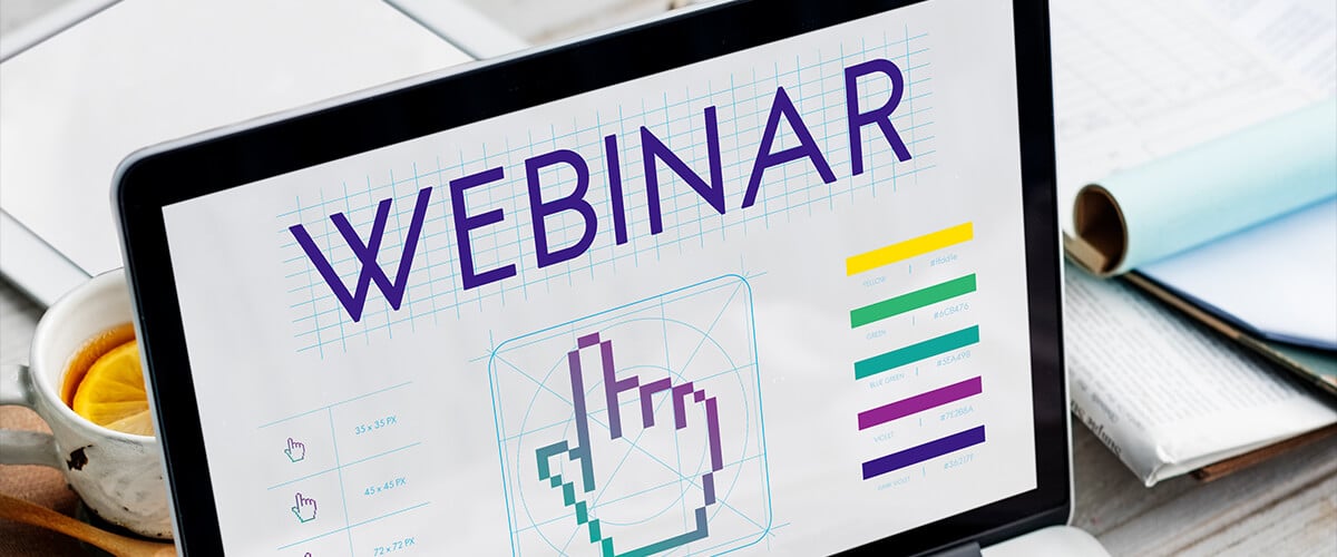 Close-up of a tablet screen displaying a webinar design concept with pixelated hand icons and color charts.
