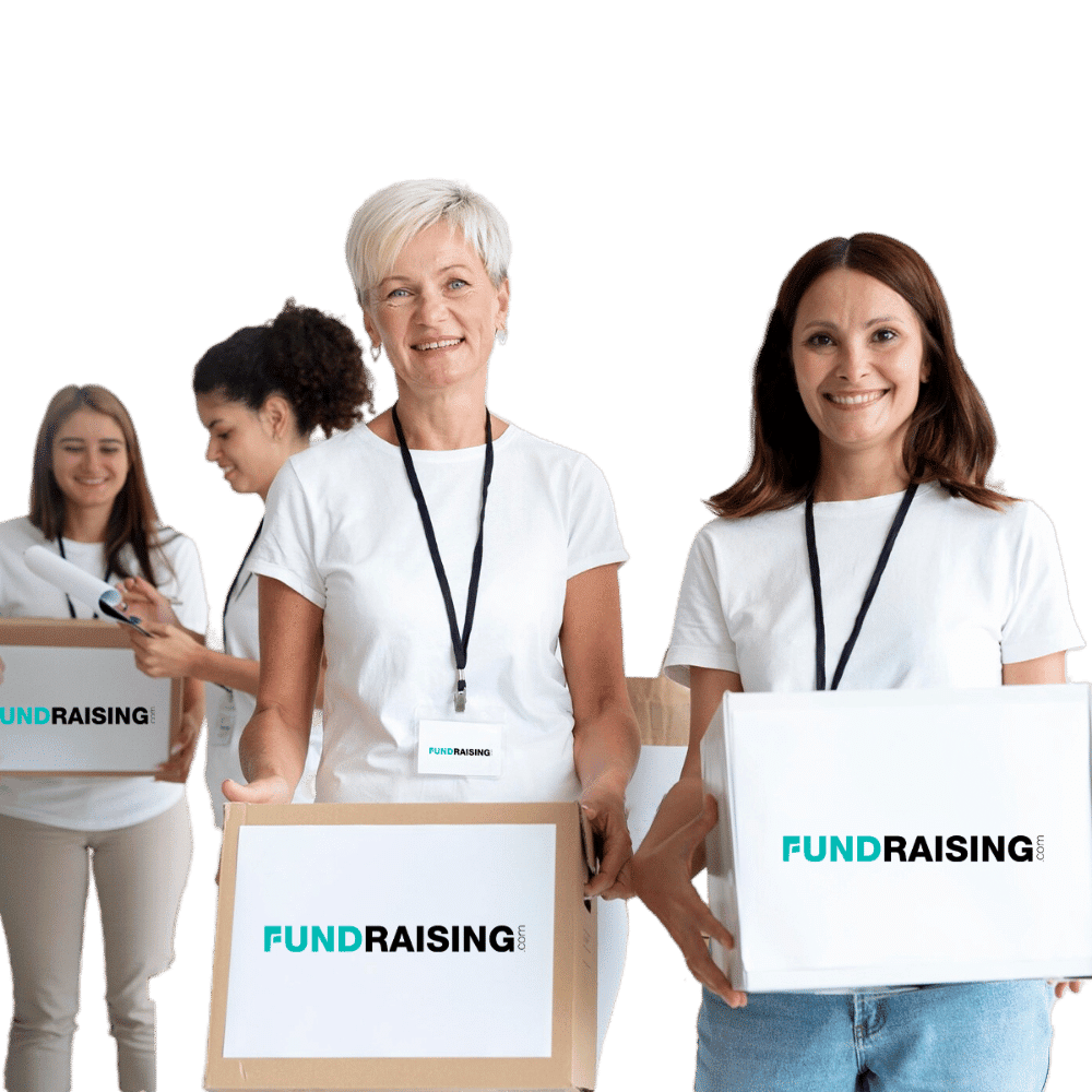 Two women smiling while holding boxes labeled "Fundraising.com," with two more women organizing supplies in the background.
